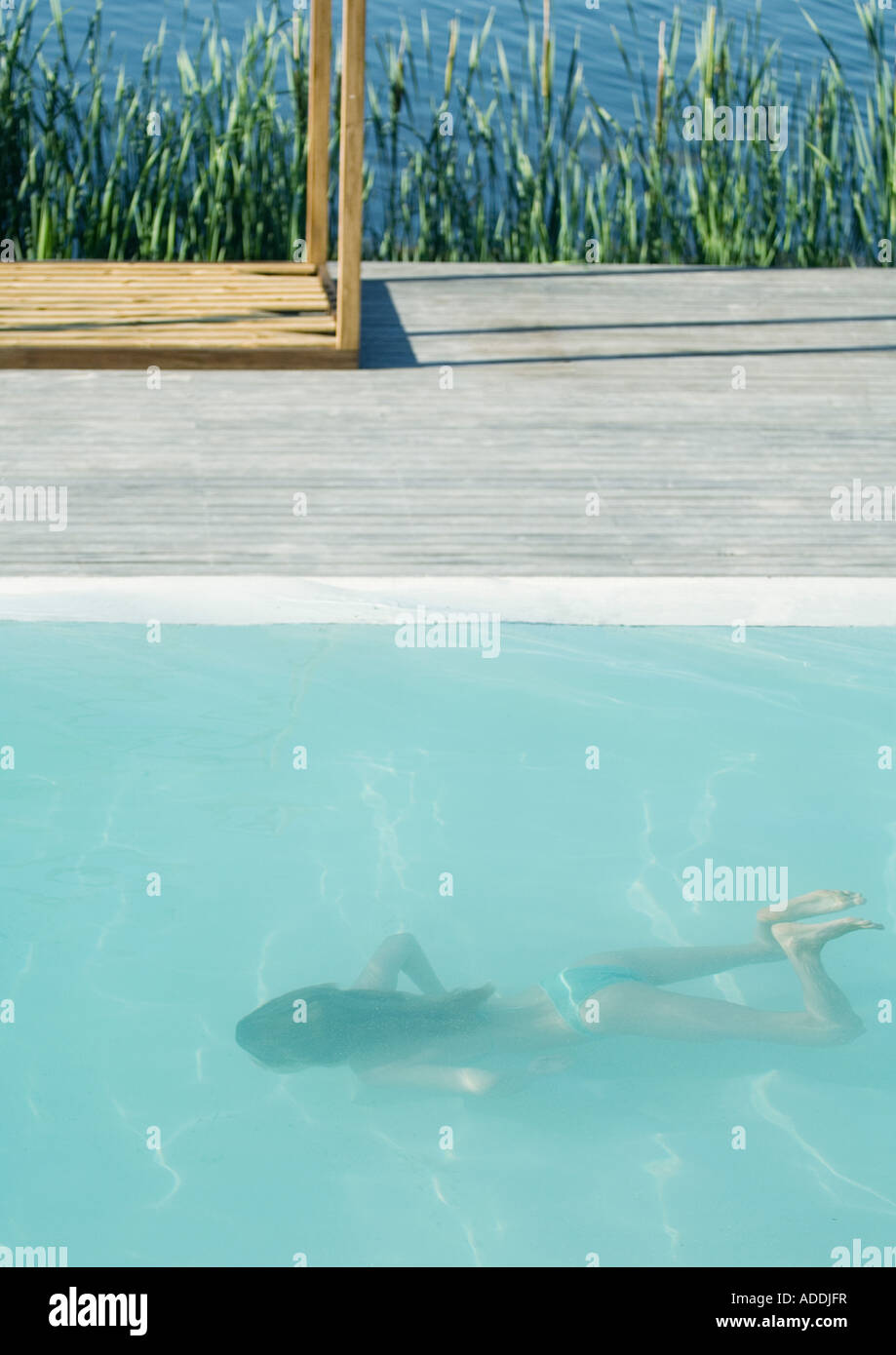 Young woman swimming underwater in pool Stock Photo - Alamy