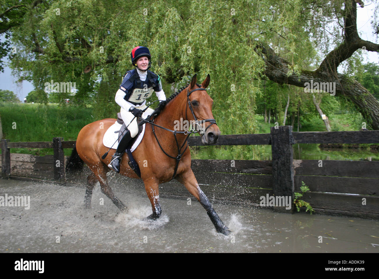 Horse and rider going through the water splash at the Borde Hill Horse Trials Stock Photo