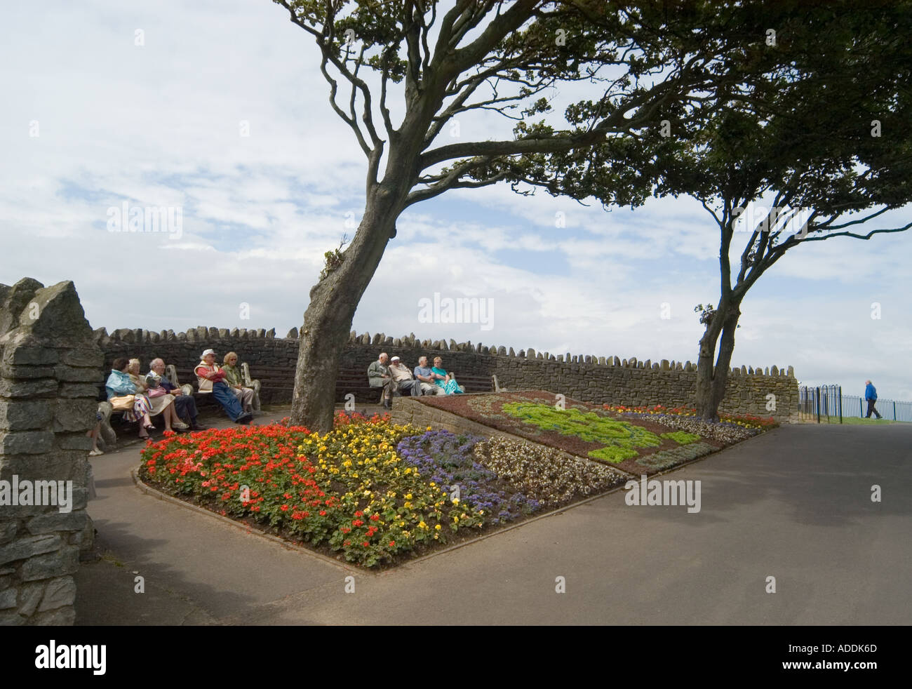 elderly people sat on benches clevedon sea front england uk great britain Stock Photo