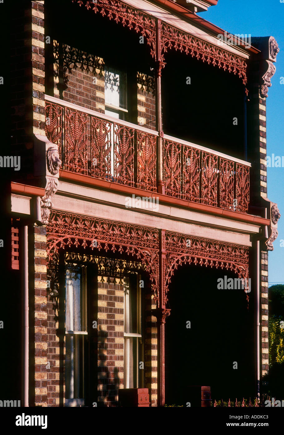 Red painted Cast ironwork Victorian terrace house in Melbourne Australia Stock Photo Alamy