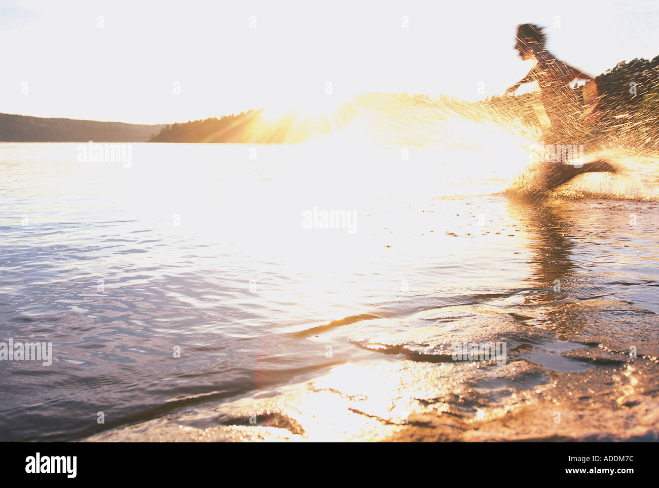 Mann laeuft ins Wasser Stock Photo