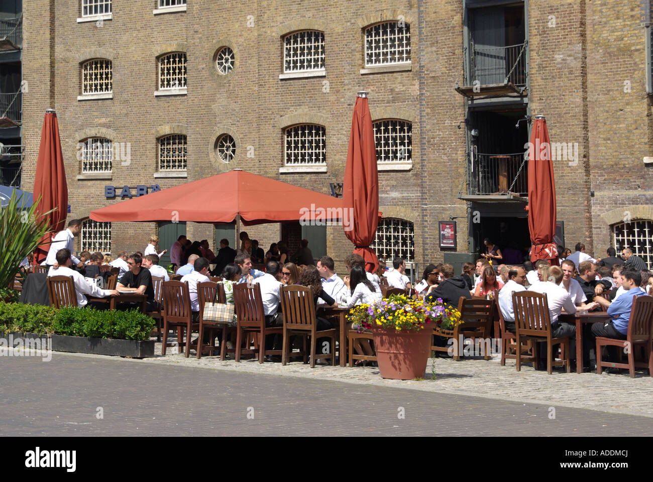 West India Quay warehouses converted to bars & restaurants alfresco eating out dining for Canary Wharf office business workers London Docklands UK Stock Photo
