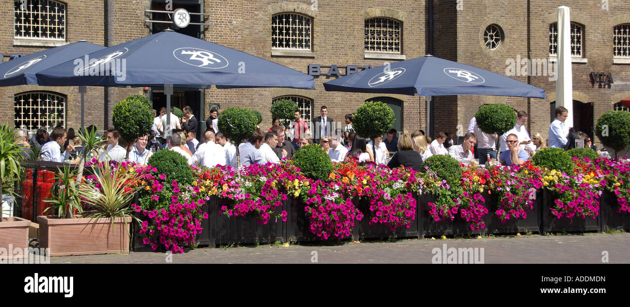 West India Quay warehouses converted to bars & restaurants alfresco eating out dining for Canary Wharf office business workers London Docklands UK Stock Photo