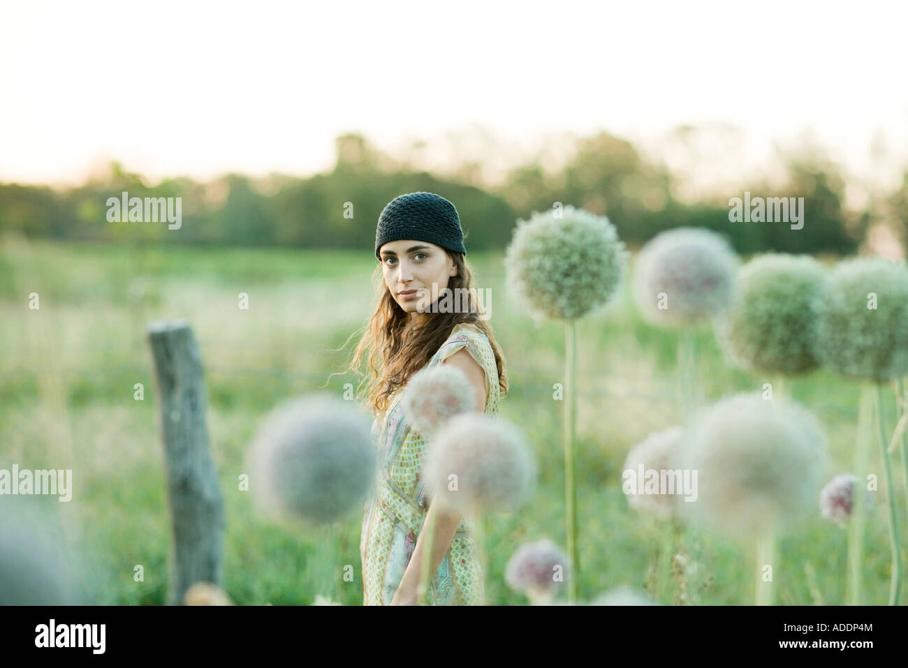 Young woman standing in field Stock Photo - Alamy