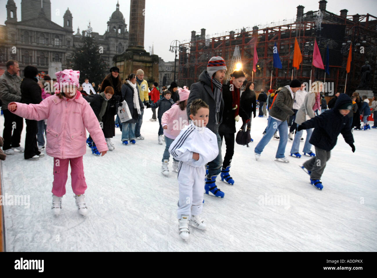 Ice Skating on Outdoor Ice Rink, Square. City Chambers in