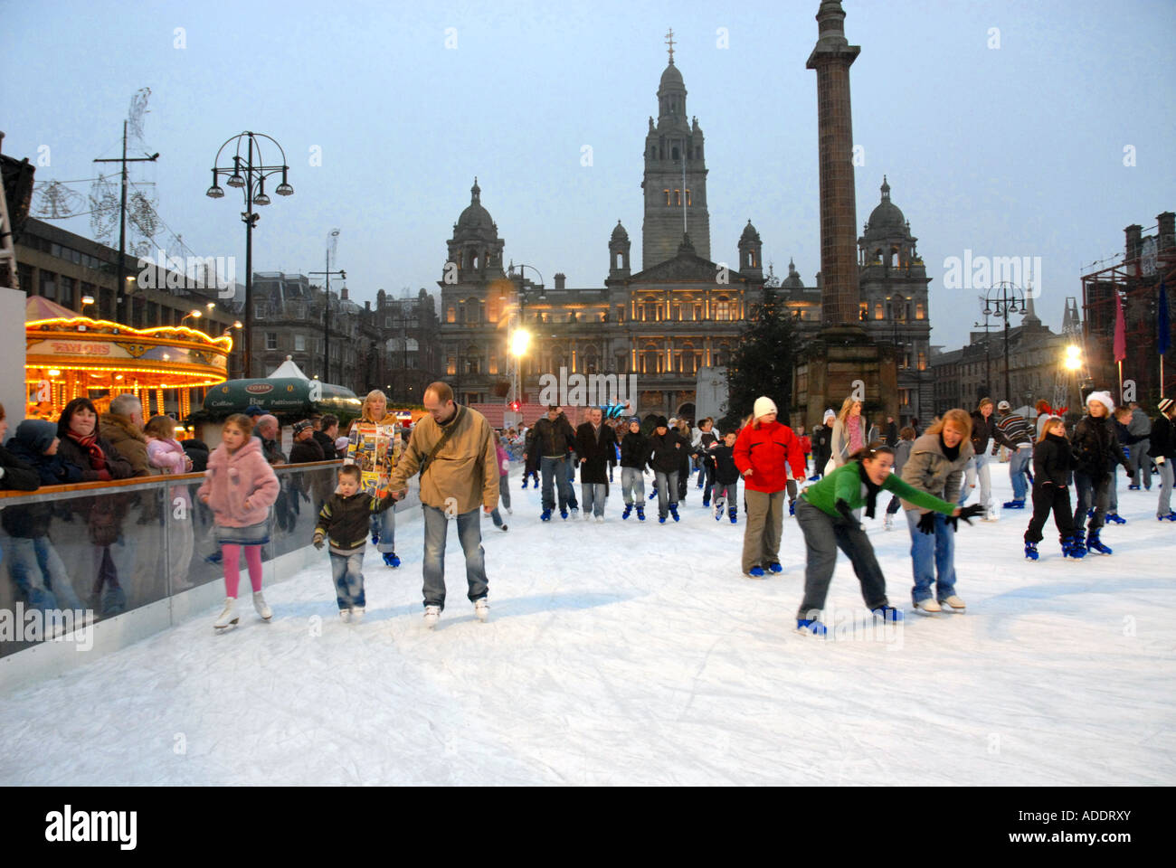 Ice Skating on Outdoor Ice Rink, Square. City Chambers in