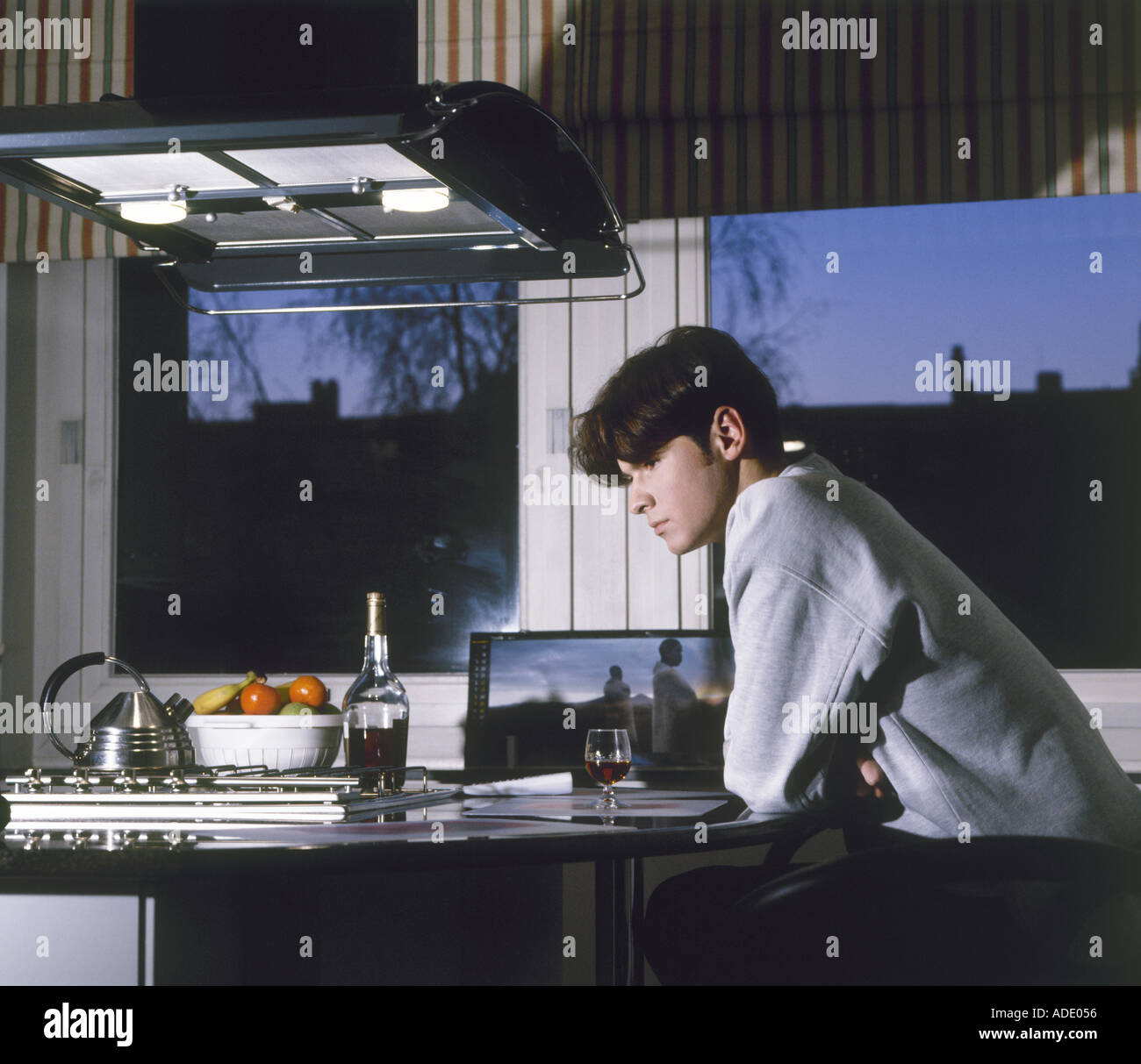 Young man having dinner at home near the window Stock Photo