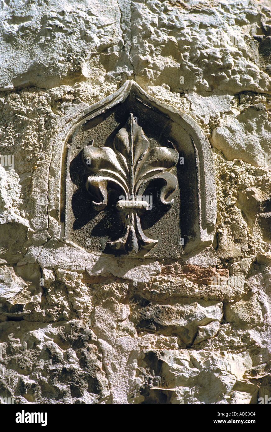 A fleur de lis set into a wall in the mediaeval Venetian town of Trogir on the Dalmatian coast of Croatia Stock Photo