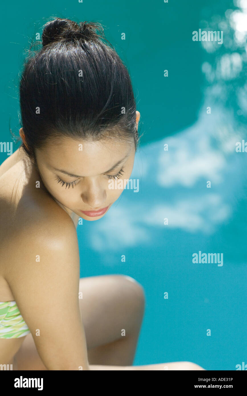 Young woman wearing bathing suit, pool in background, high angle view Stock Photo Alamy