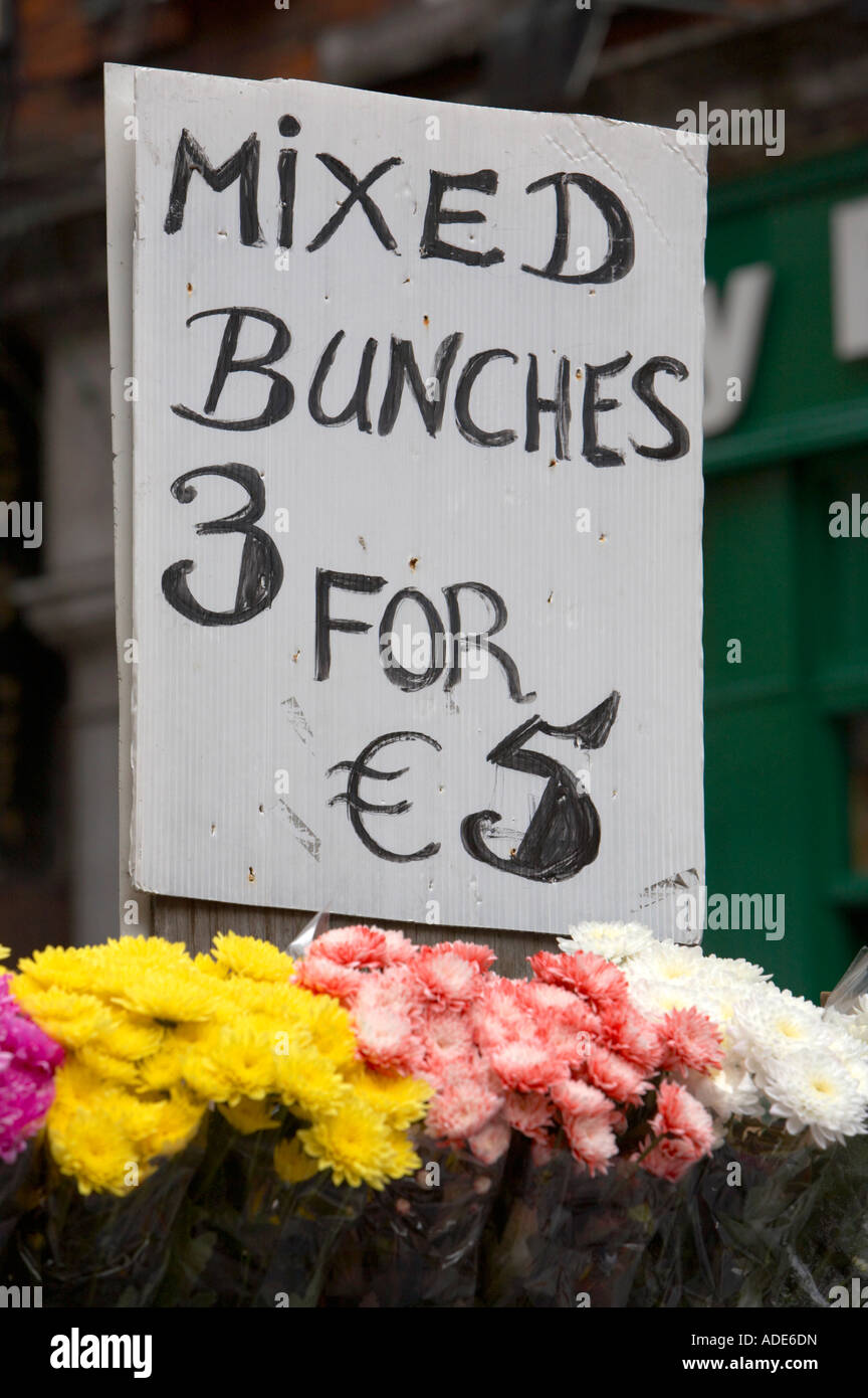 mixed bunches of flowers signs with bouquets of flowers 3 three for 5 five euro prices at outdoor market dublin Stock Photo