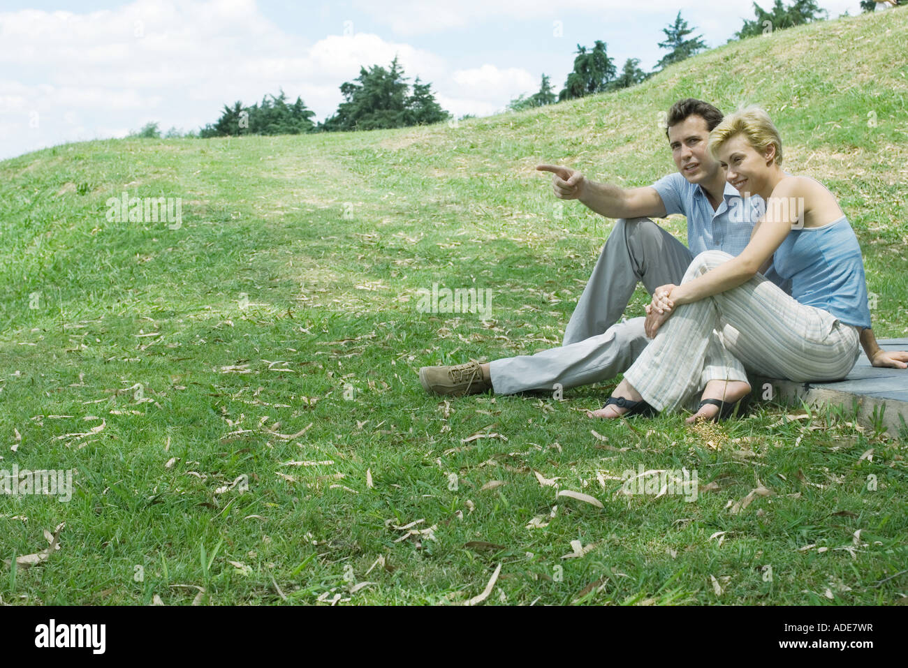 Young couple sits on grassy hi-res stock photography and images - Alamy