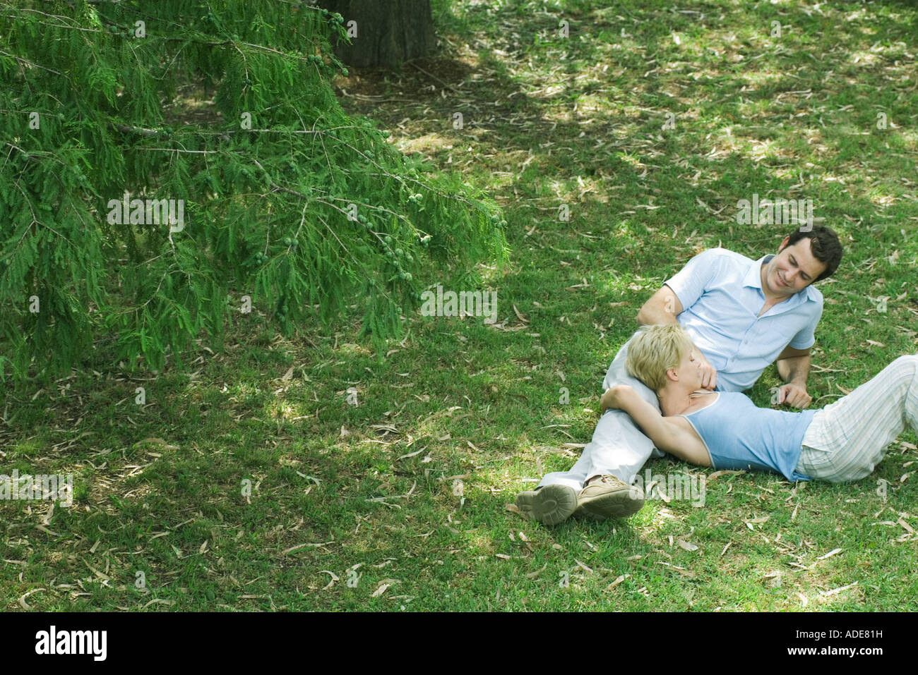 Couple reclining on grass Stock Photo Alamy
