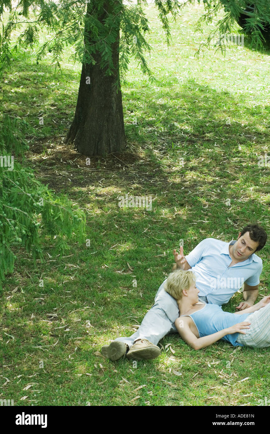 Couple reclining on grass Stock Photo Alamy