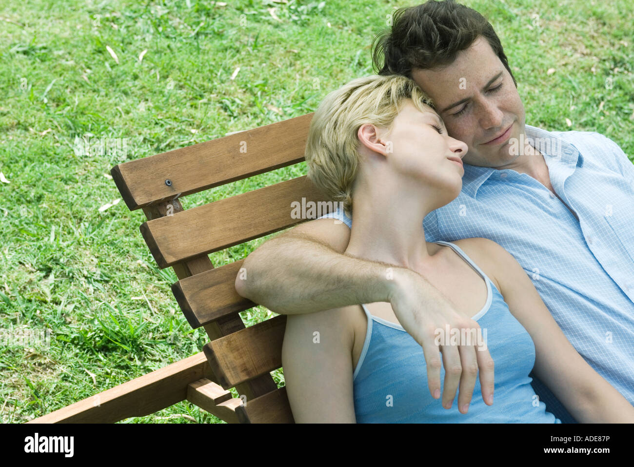 Couple reclining on lounge chair together Stock Photo Alamy
