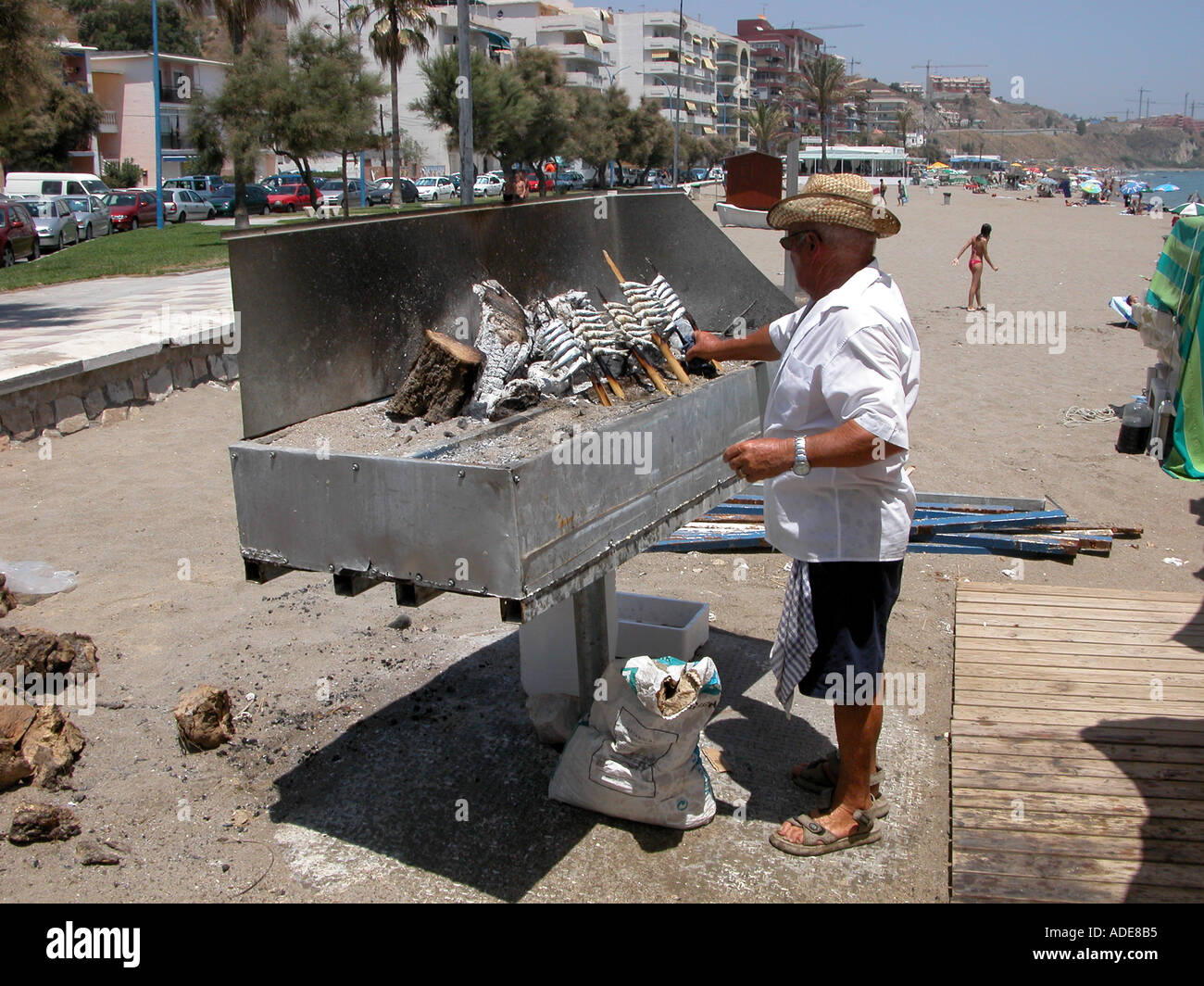 Man cooking sardines on the beach, Carvajal, Fuengirola, Costa del Sol