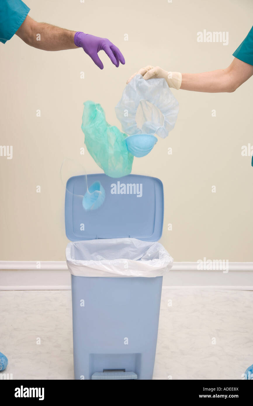 Healthcare waste being placed into plastic bag/can. Stock Photo