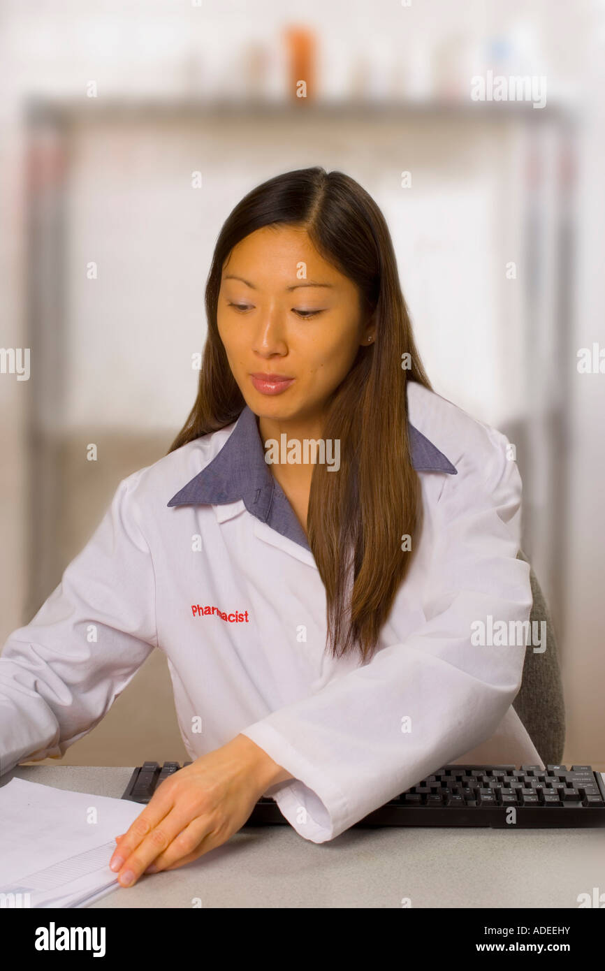Pharmacist Using A Computer Pharmacist using computer in the pharmacy Stock Photo - Alamy