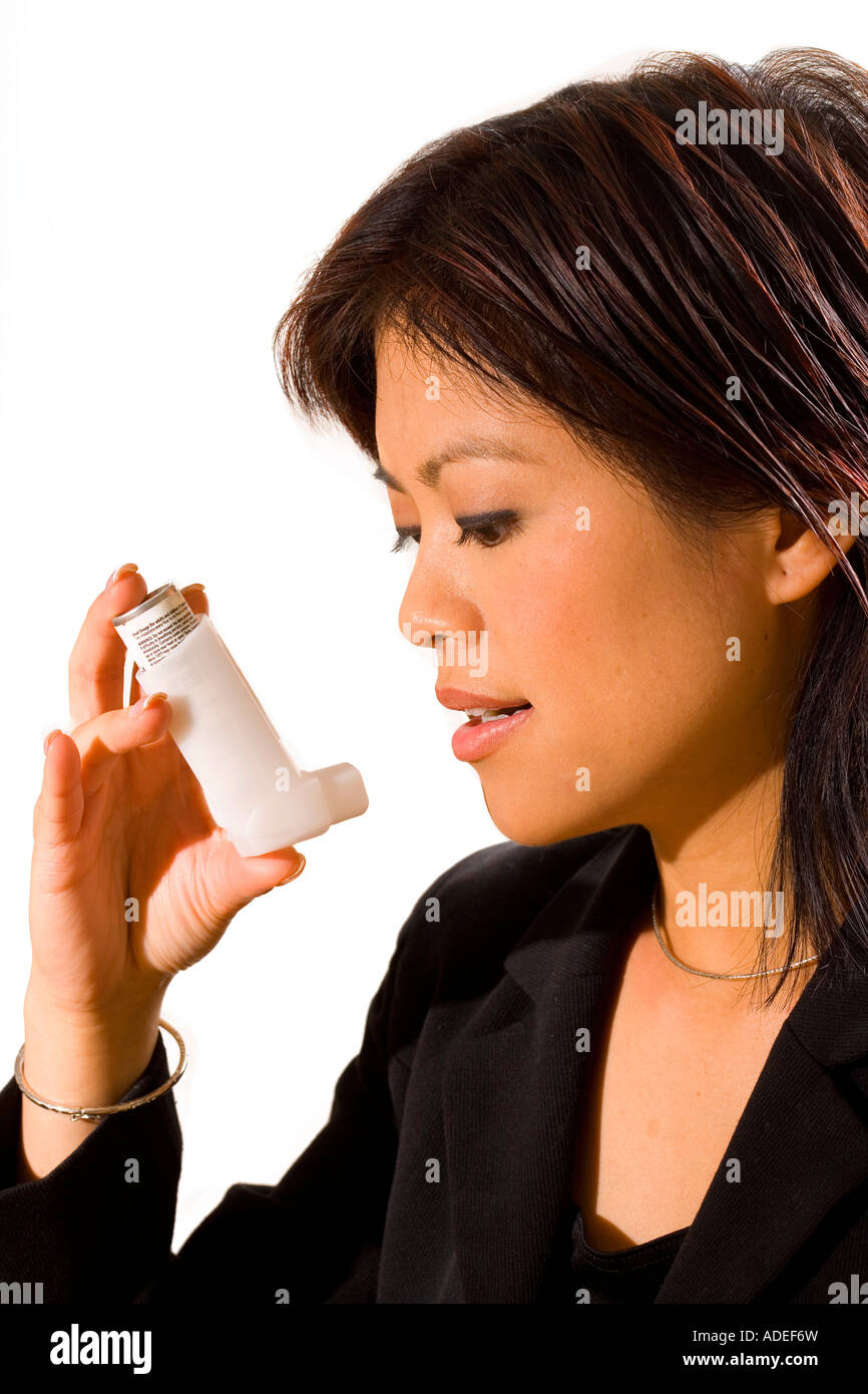 Woman is about to take a premeasured dosage of medication for her asthma using a bronchial