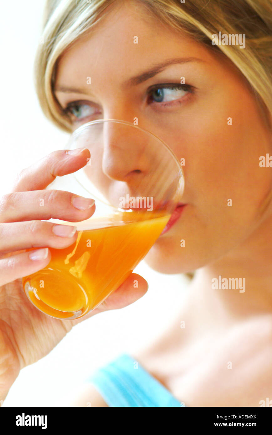 Closeup of woman drinking orange juice Stock Photo Alamy