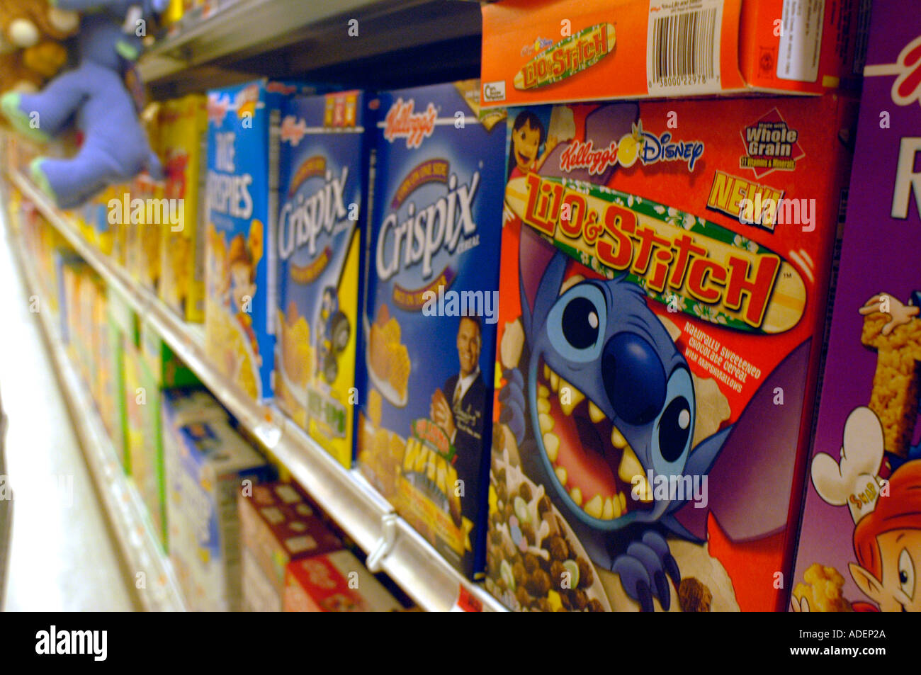 Boxes of breakfast cereal featuring cartoon characters on supermarket shelves  Stock Photo