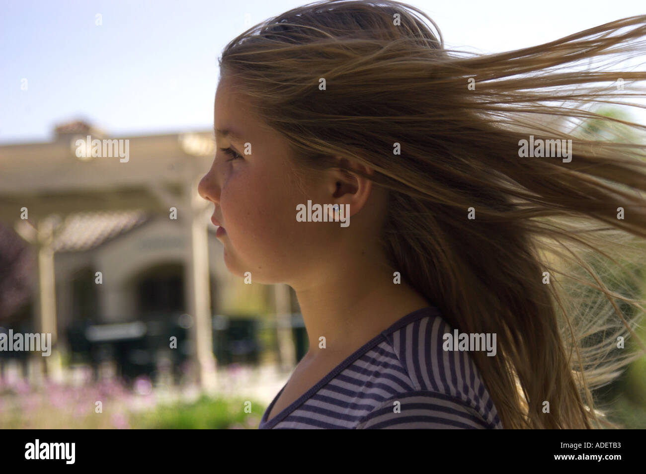 wind blowing in girl s hair Stock Photo