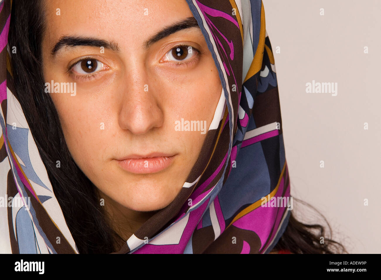 Young serious middle-eastern woman wearing head scarf. Stock Photo