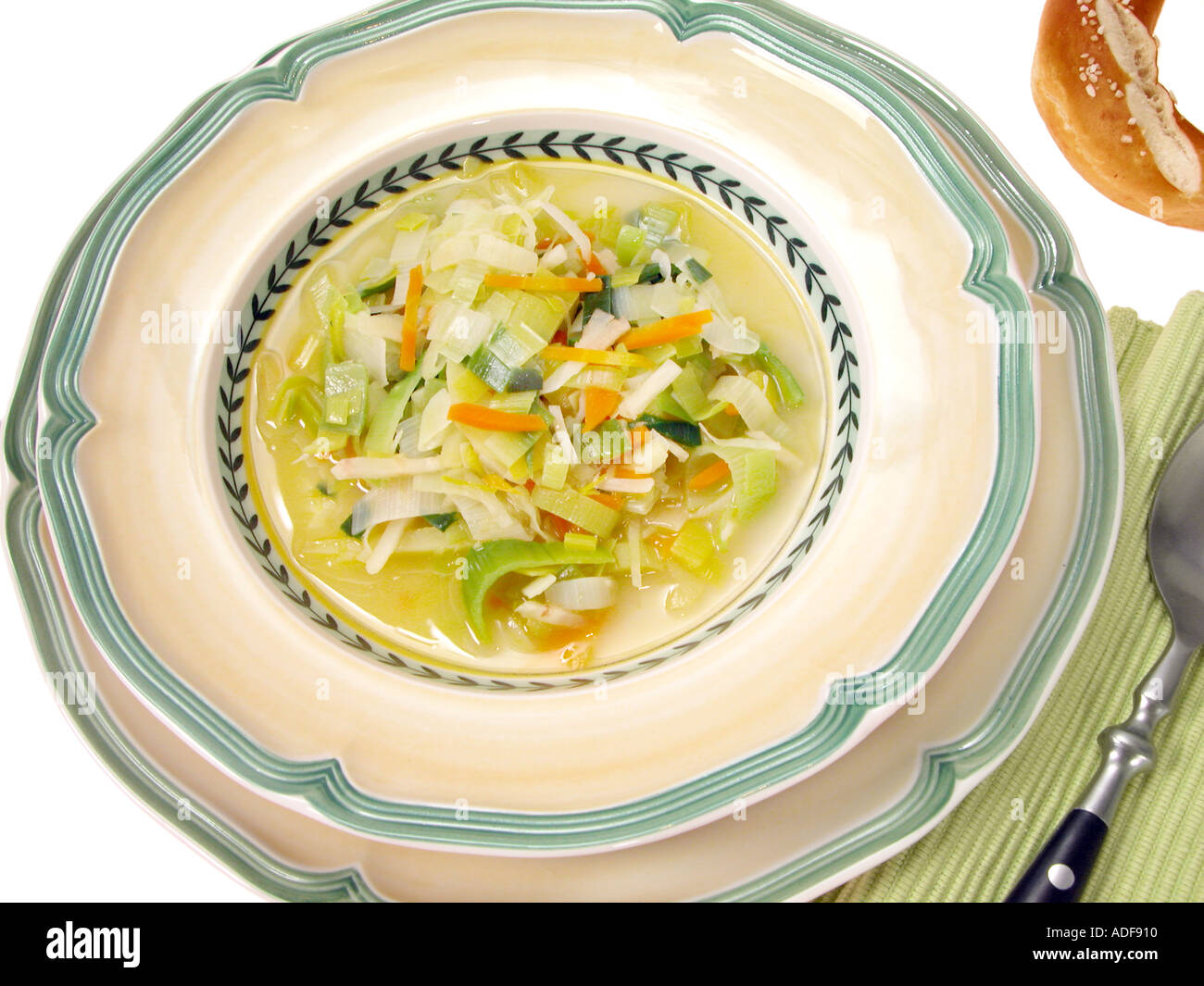serving the leek soup spoon plate soupplate Stock Photo