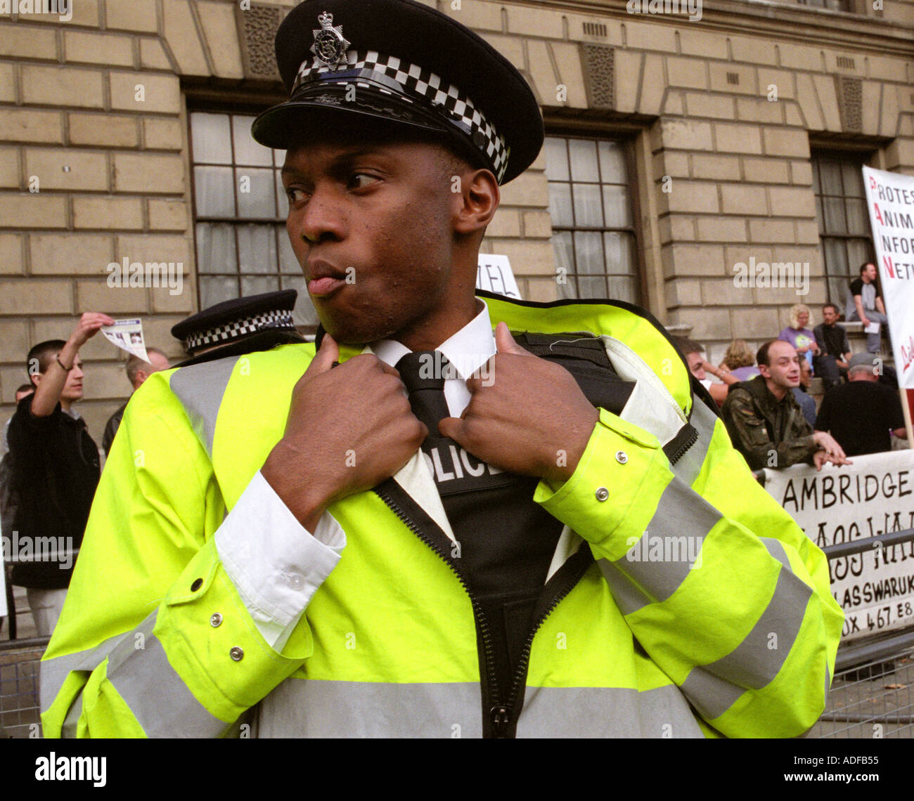 Black police officer talking on his radio whilst attending a