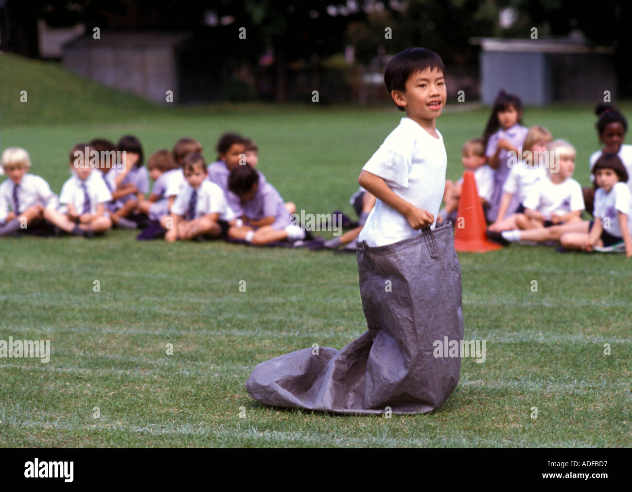 Children taking part in Sports day sack race at end of year sports day Stock Photo