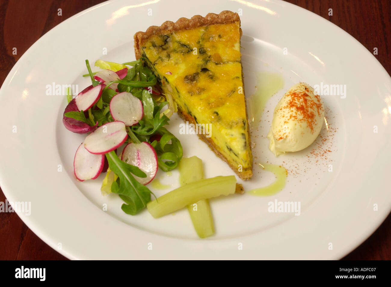 plate of food. Baked crab tart with saffron at The Walnut Tree Inn Llandewi Skirrid Abergavenny Monmouthshire South Wales UK Stock Photo