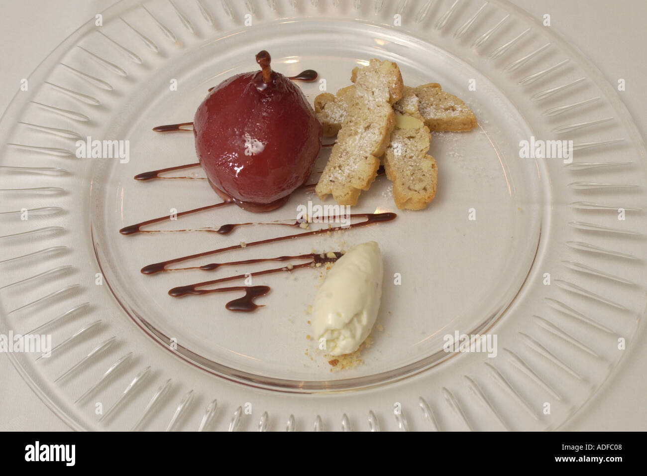 Poached pear in red wine with mascarpone catuccin biscuits at The Walnut Tree Inn Abergavenny Monmouthshire South Wales UK Stock Photo