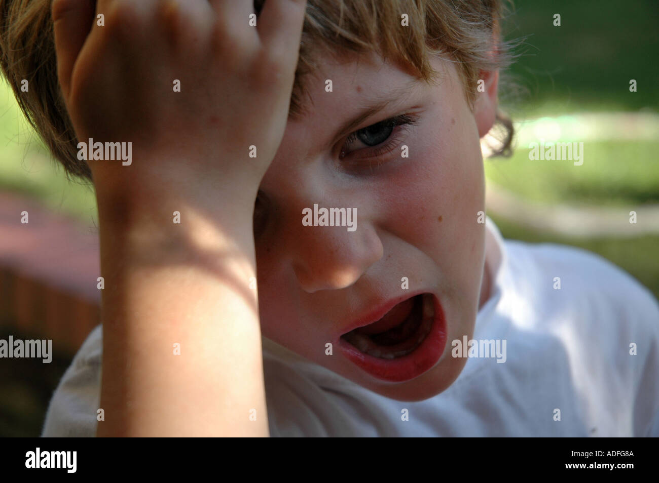 young boy frustrated and dismayed, hand on head and open mouth Stock Photo