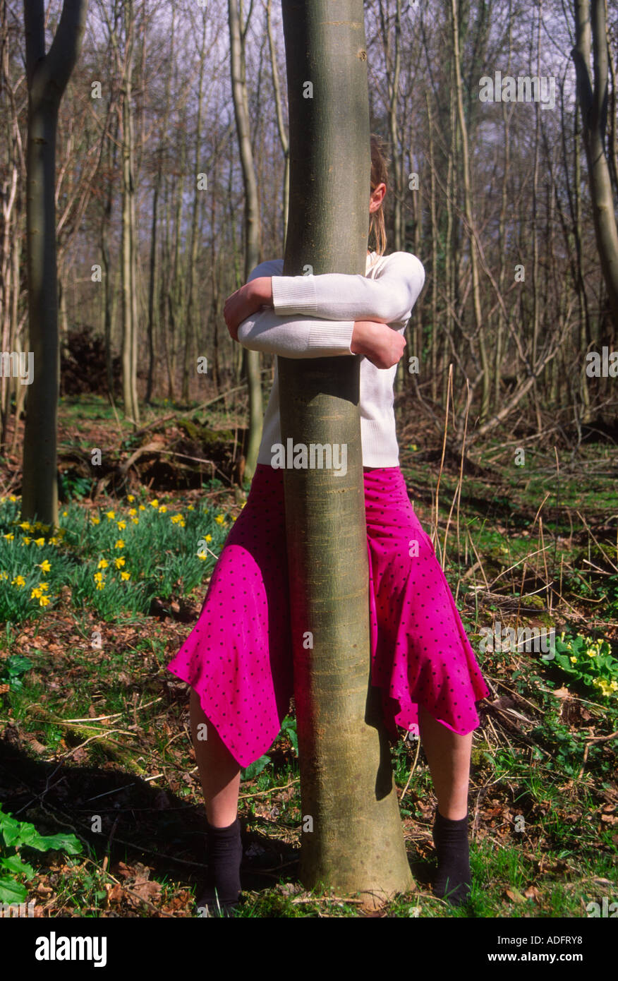 Young girl hugging a tree woodland in springtime Stock Photo Alamy