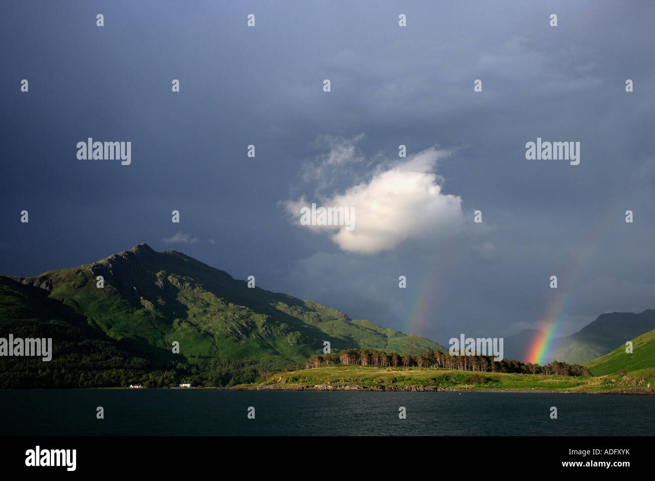 A RAINBOW AND DARK BROODING SKY MAKE A DRAMATIC BACKDROP TO INVERIE KNOYDART. Stock Photo
