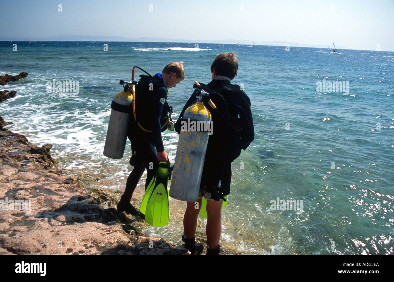 Two boys going scuba diving Junior Open Water Lighthouse Reef Dahab Sinai Red Sea Egypt Luke Hanna age 13 years Jordan Mayes age Stock Photo
