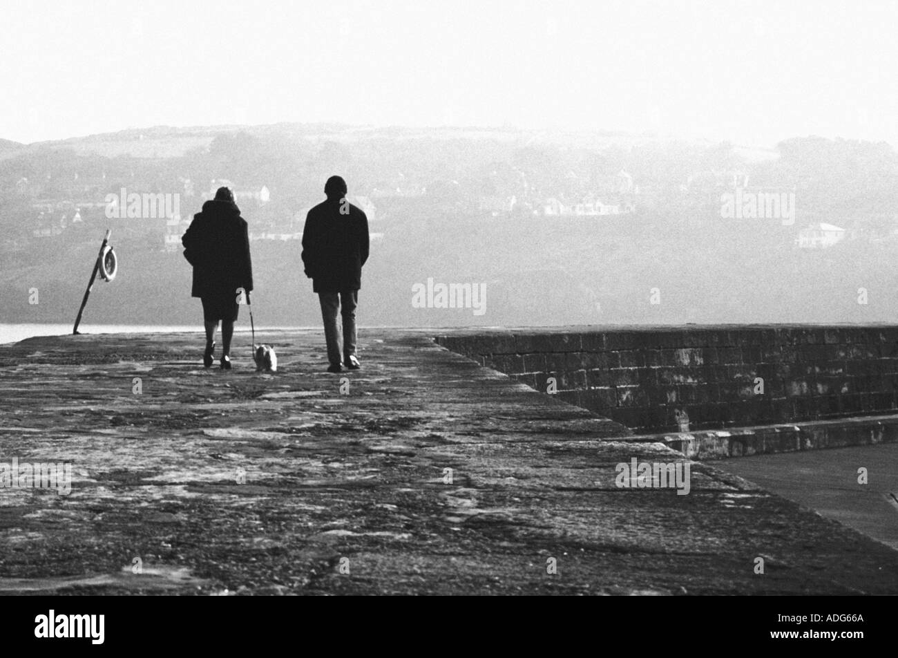 Two people walking along a path B W Stock Photo