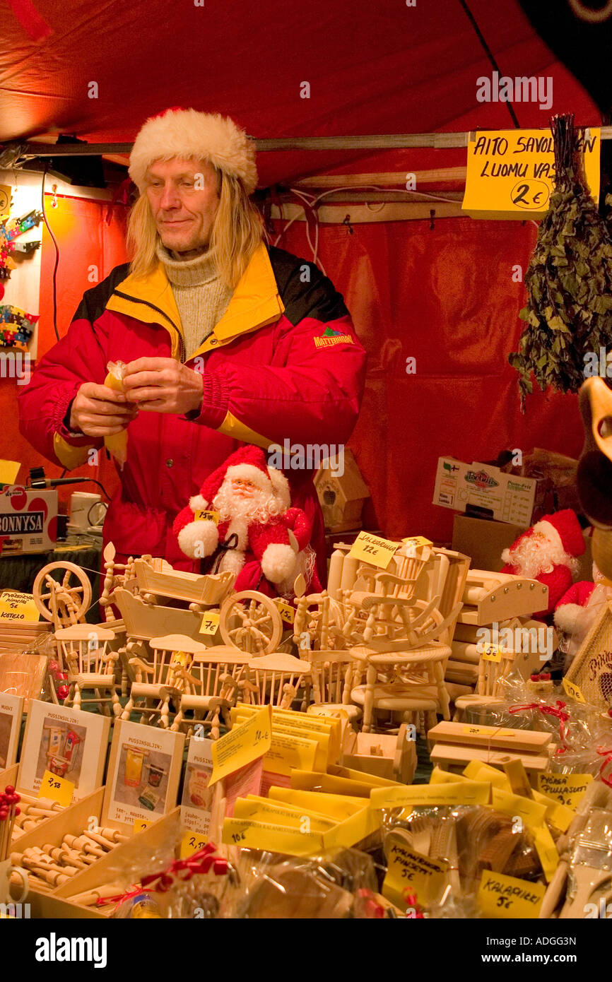 A toy maker shows off his supply of fine wooden toys, St Thomas Christmas market Helsinki Stock Photo