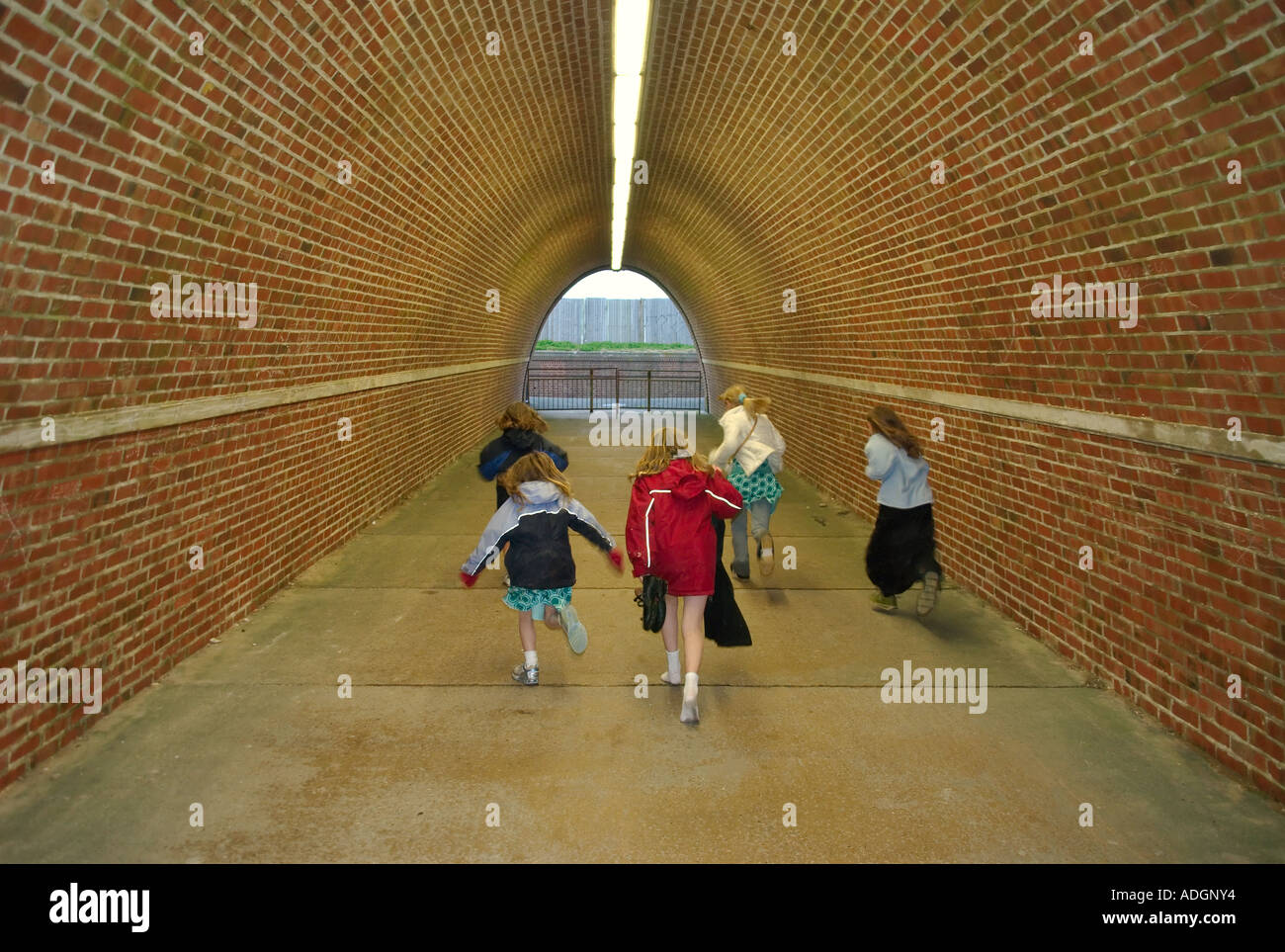europe uk england sussex children running away in tunnel under road Stock Photo