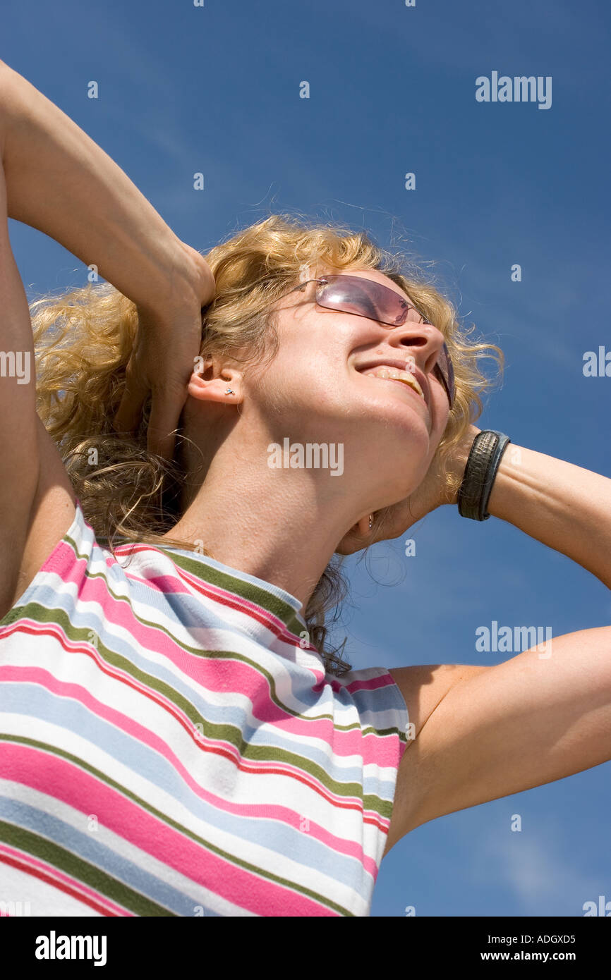 Young woman smiling in sunshine Stock Photo