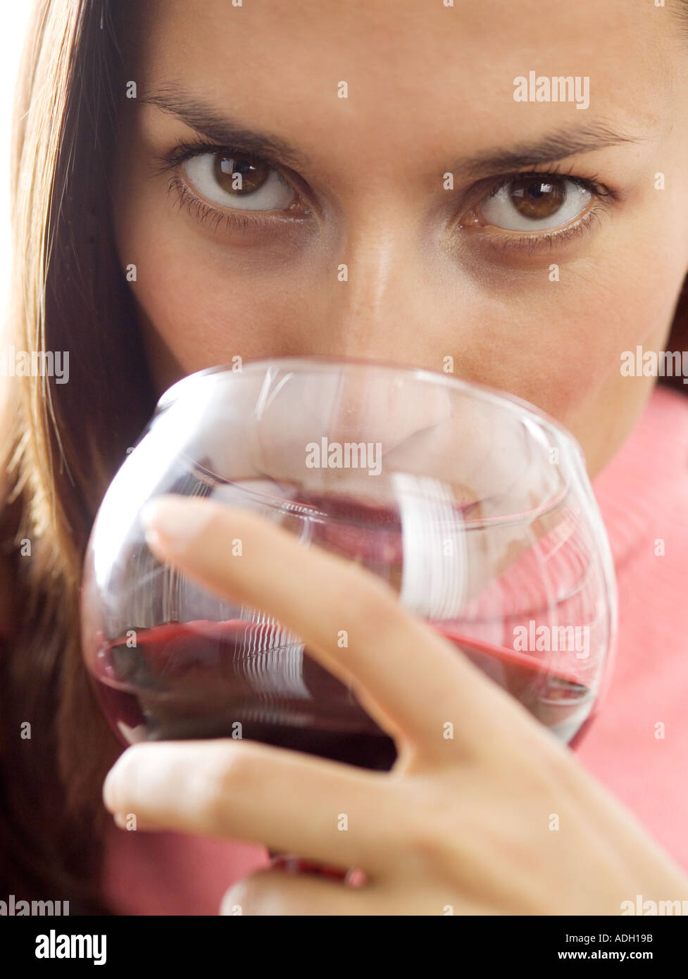 A woman sipping red wine Stock Photo