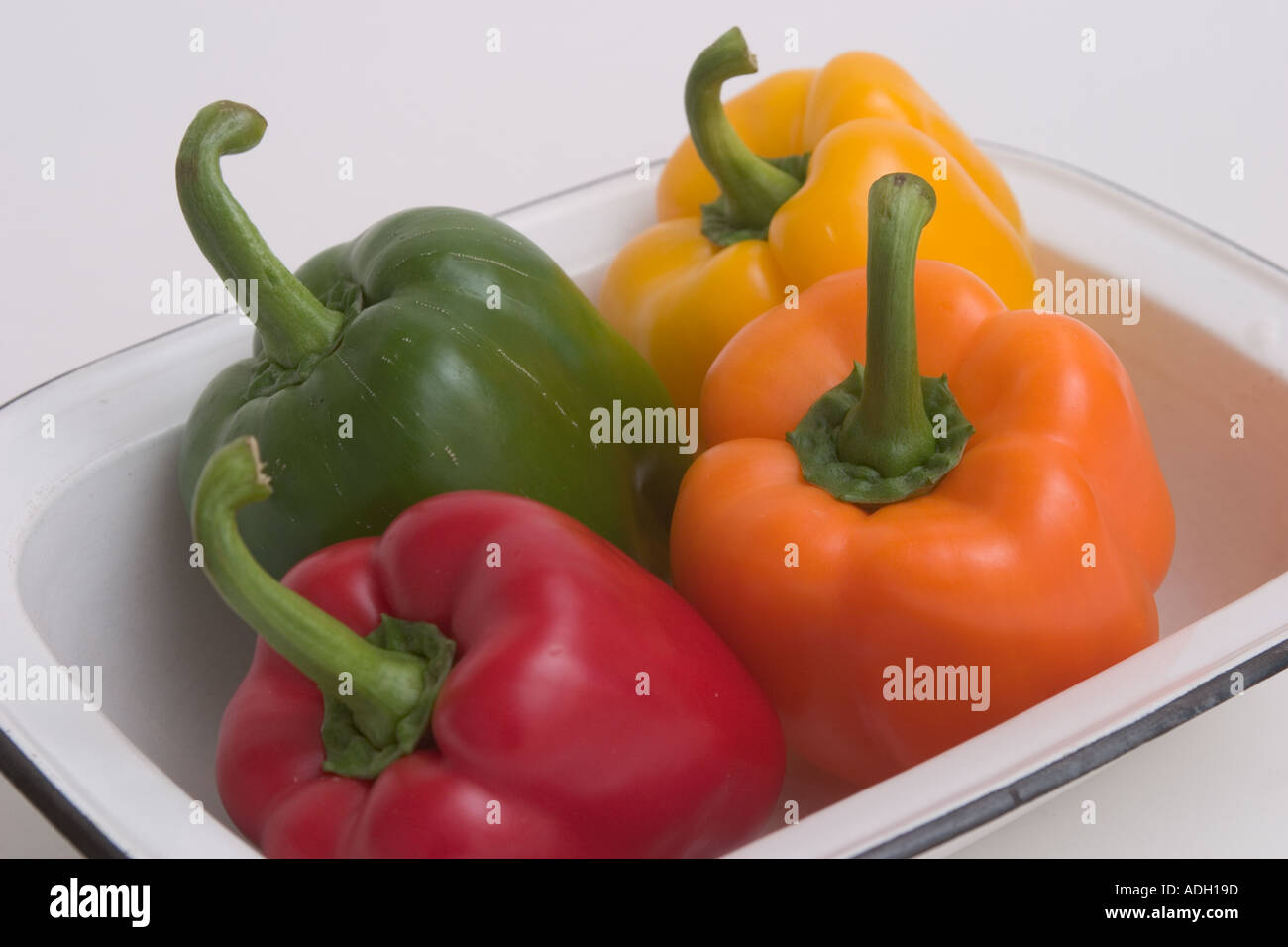 Four Colourful bell peppers in tray red yellow green orange Stock Photo ...