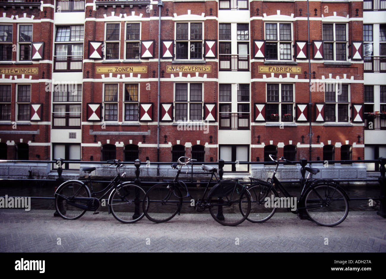 ONLY WAY TO TRAVEL 02 bicycles by canal and warehouse hotel amsterdam holland THIS IS 1 OF 1 SIMILAR PICS AND 1 OF 200 TOTAL PIC Stock Photo