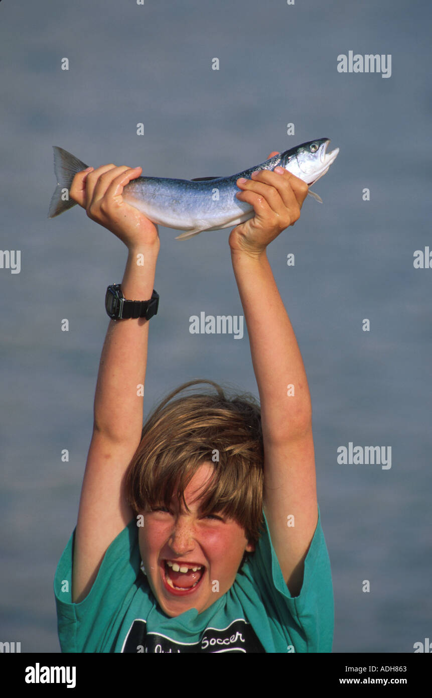 7 year old Boy holds Dolly Varden Juneau SE AK summer portrait Stock Photo