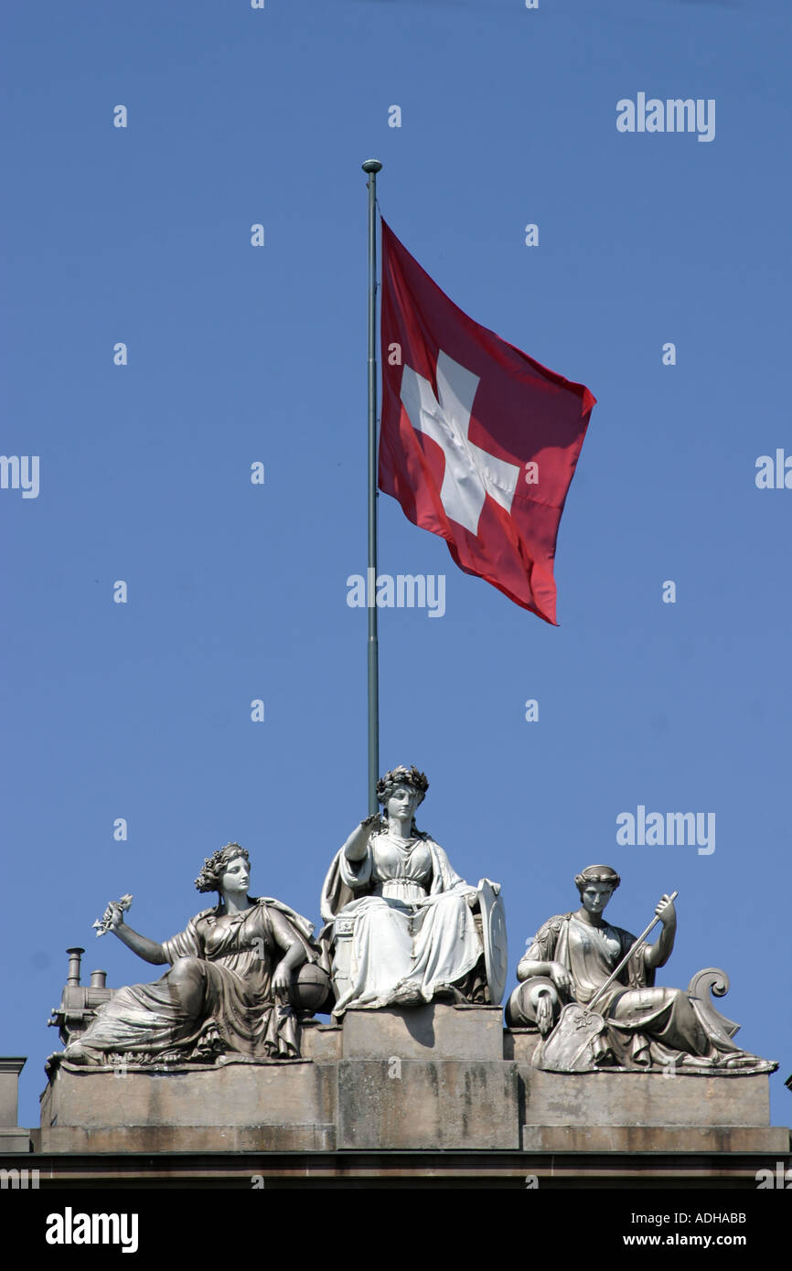 Switzerland Zurich main station sculptures on roof top with swiss flag 1 august national day  Stock Photo