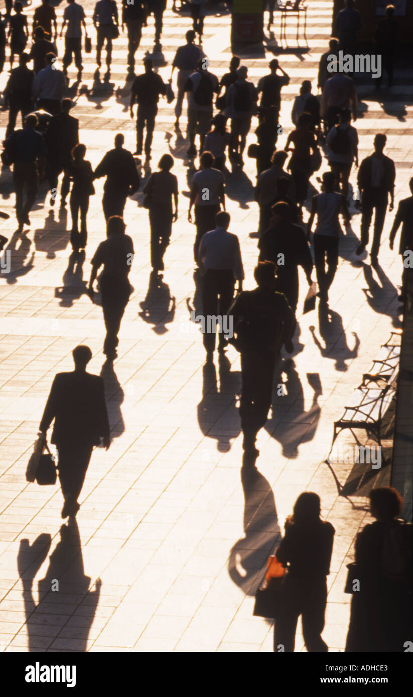 People walking on city street in afternoon light Stock Photo