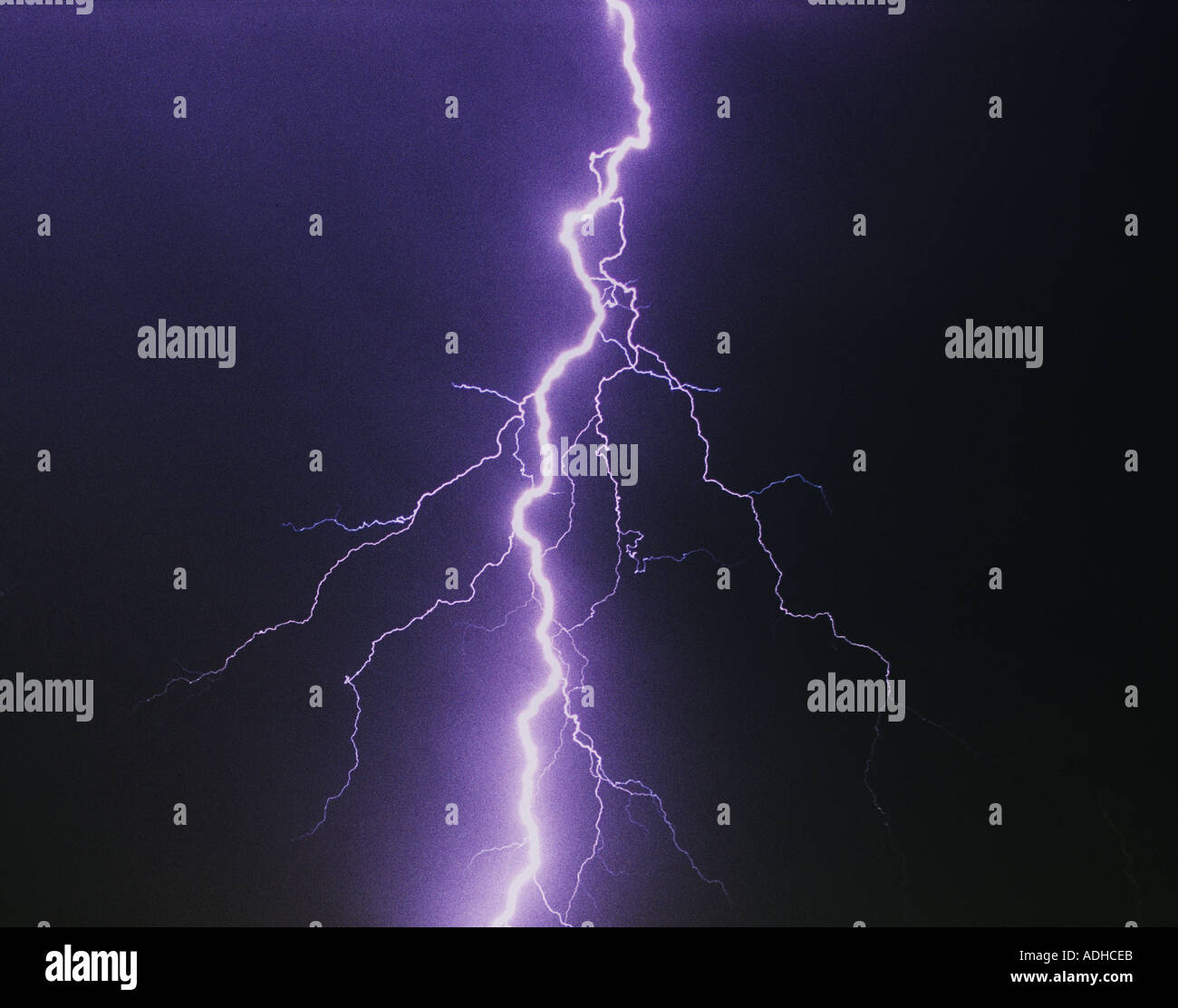 Lightning bolt splitting night sky Stock Photo