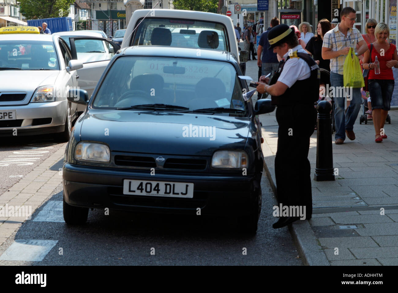 Traffic warden writing out a parking ticket Law enforcement officer Stock Photo