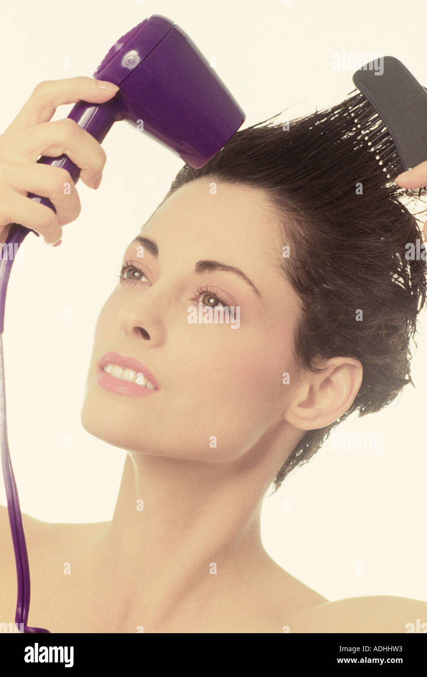 Close up woman using hair dryer hi-res stock photography and images - Alamy