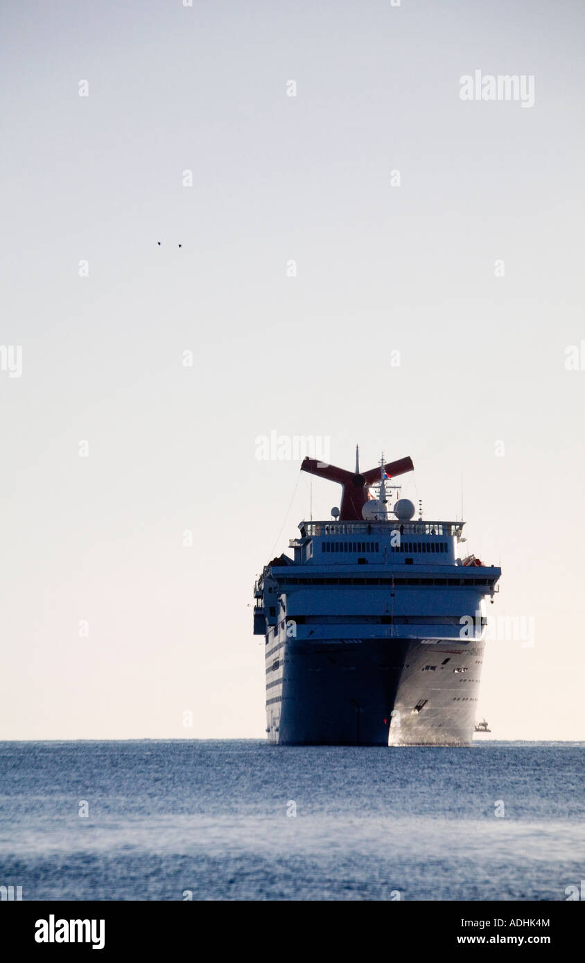 A single ocean liner is seen cruising on a calm sea in the soft light of early morning. Stock Photo