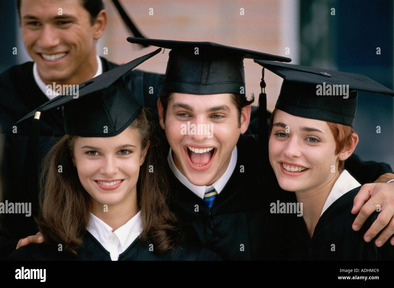 Portrait of a group of college students wearing graduation outfits